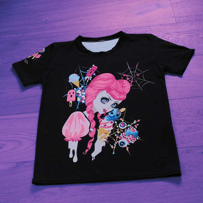 Artfully arranged, the ‘Demon Kawaii Ice Cream Pastel Goth’ t-shirt rests on the floor, showcasing its intricate design. Pastel goth, kawaii, yami kawaii, and shoujo manga elements come together in this captivating image, with a delightful depiction of a demon enjoying an ice cream against a dreamy pastel background.