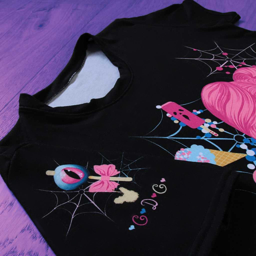 Focusing on the sleeve, this shot accentuates the ‘Demon Kawaii Ice Cream Pastel Goth’ t-shirt’s intricate detailing. Pastel goth, kawaii, yami kawaii, and shoujo manga elements intertwine in the design, extending to the sleeve with captivating artistry. The sleeve becomes a canvas for the whimsical narrative, enhancing the overall charm of the shirt.