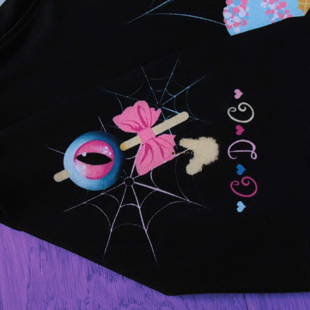A close examination of the sleeve unveils the artful nuances of the ‘Demon Kawaii Ice Cream Pastel Goth’ t-shirt. Pastel goth, kawaii, yami kawaii, and shoujo manga influences intricately decorate the sleeve, contributing to the overall enchanting aesthetic. The detailed sleeve design adds an extra layer of charm to this captivating piece.